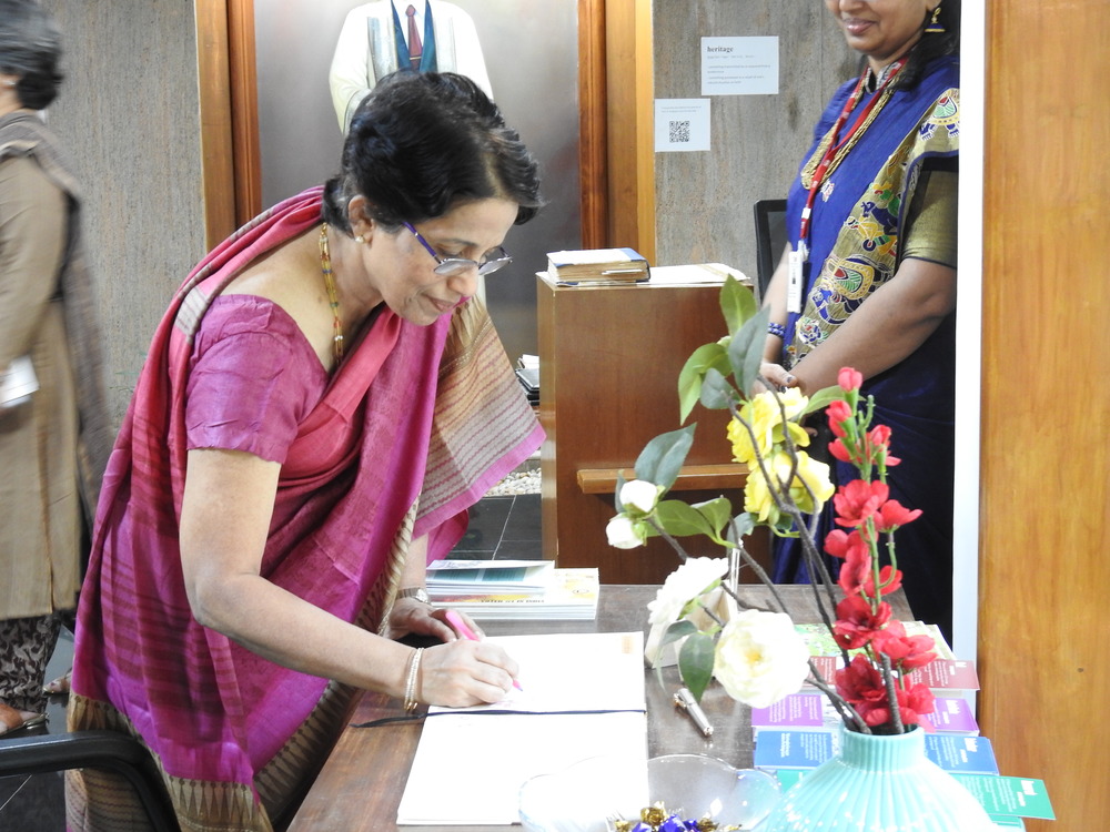 Mrs. Elizabeth writes in the visitors' book.